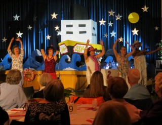 (Image: The Cabaret Performers Dance in Front of a Ship Set)