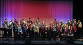 (Image: The ScotianAires on Stage with Coloured Drapes Behind)