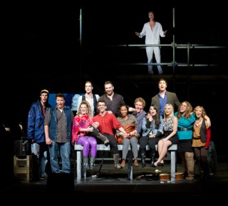 (Image: The Cast Sings Seated on a Table with Angel on the Upper
  Scaffolding)