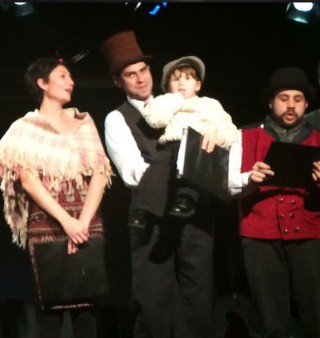 (Image: Scrooge Holds Tiny Tim Beside Cast)