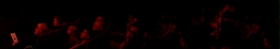 (Image Below: Audience Dimly Illuminated by Reflected Light)